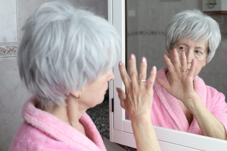 Older Woman Trying to Recognize Herself in the Mirror