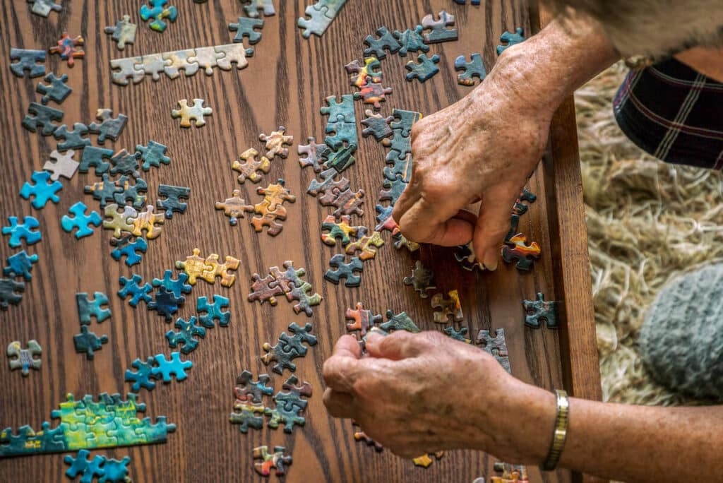 Older adult putting a puzzle together