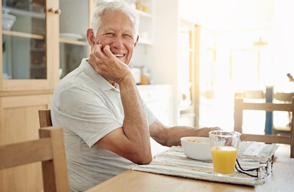 Older adult happily having breakfast