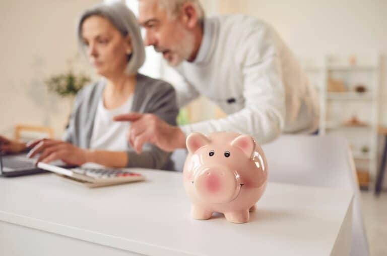 Couple of older adults and a piggy bank