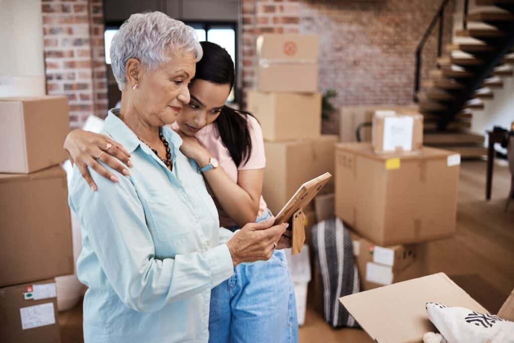 Adult daughter comforting mom in the moving process