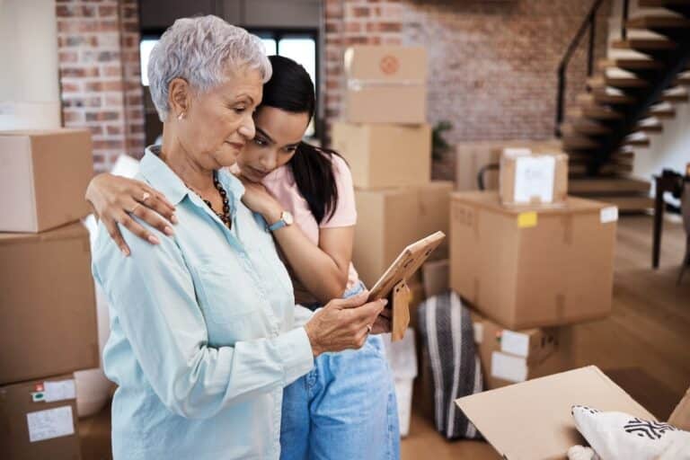 Adult daughter comforting mom in the moving process