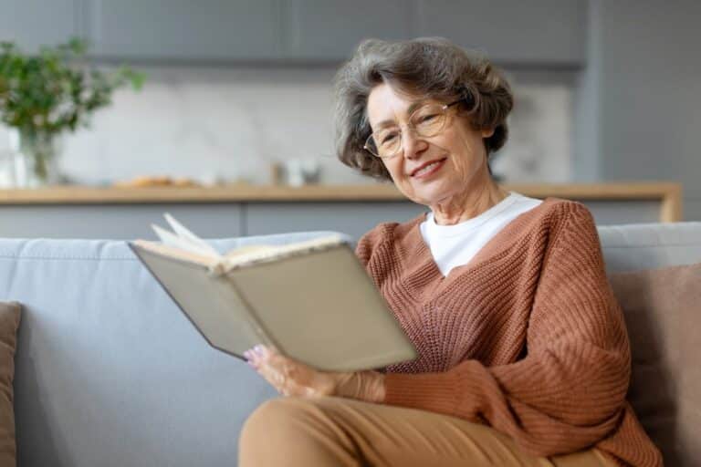 Older woman reading a book.