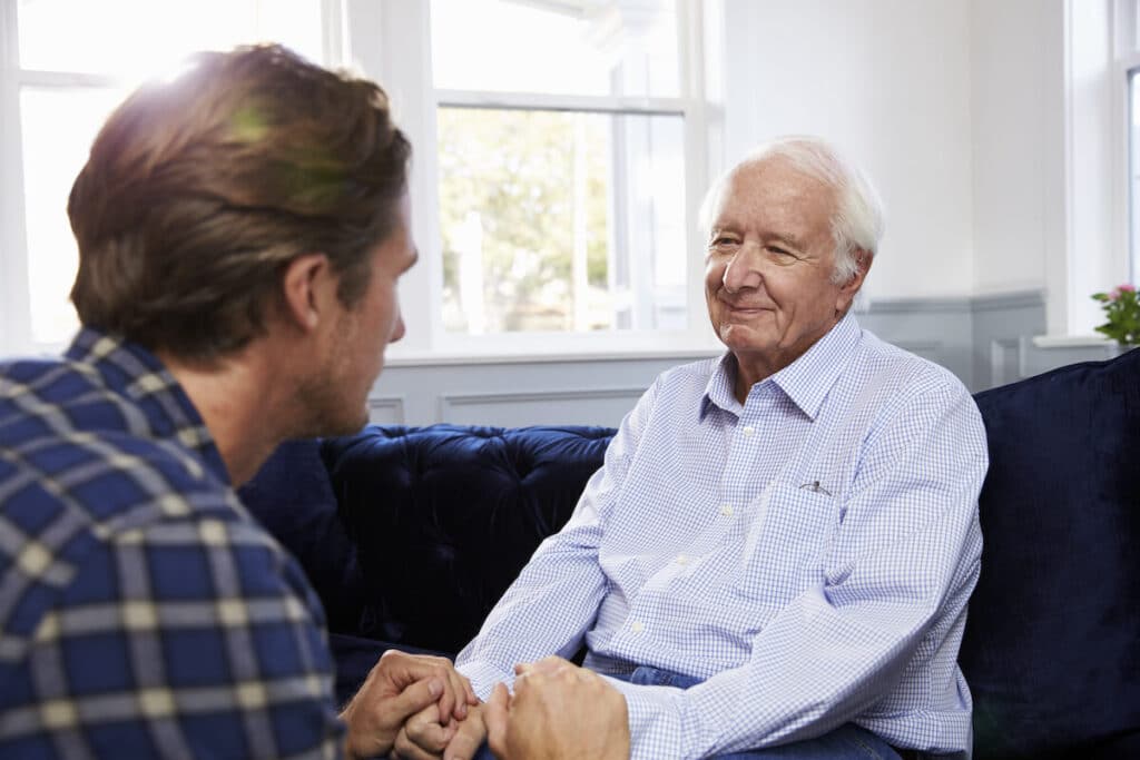 Adult son talking to parent